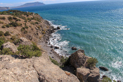 High angle view of rocks on beach against sky