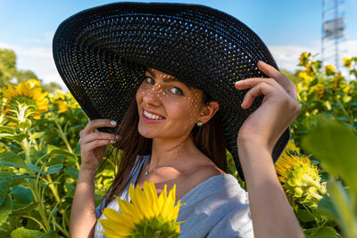 Portrait of beautiful sensual brunette in elegant hat, pattern of shadows falling on her face