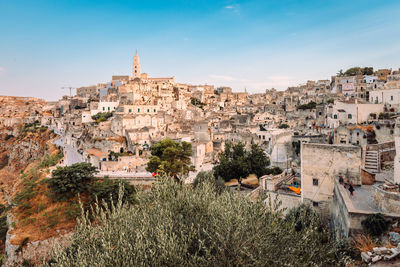 Wide view of the sassi di matera from the belvedere colombo with people blue sky with clouds