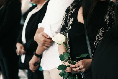 Midsection of couple holding hands