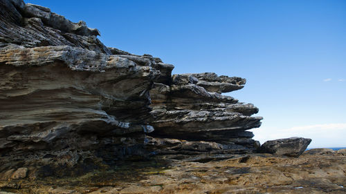 Low angle view of rock formation against sky