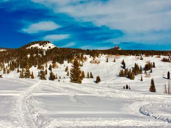 Scenic view of snow covered landscape against sky