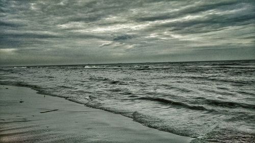 Scenic view of sea against cloudy sky
