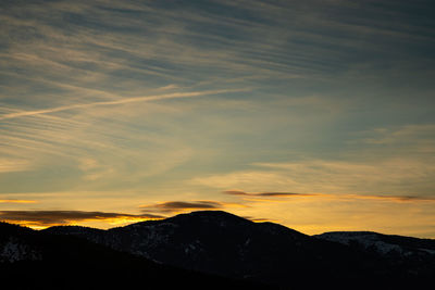 Scenic view of silhouette mountains against sky during sunset