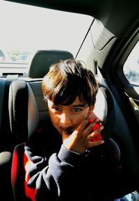 Portrait of boy sitting in car