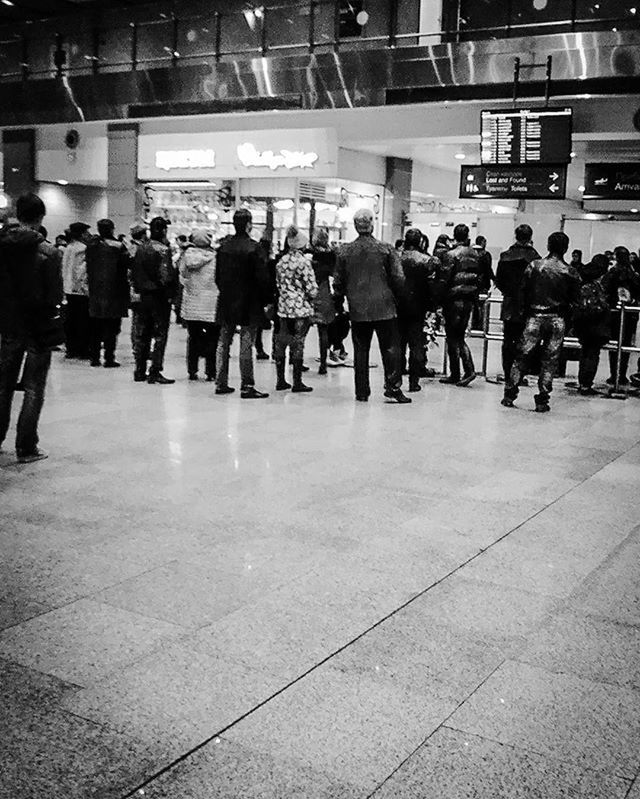 large group of people, men, person, indoors, architecture, walking, built structure, lifestyles, city life, railroad station, city, medium group of people, leisure activity, public transportation, tiled floor, flooring, building exterior, group of people, travel