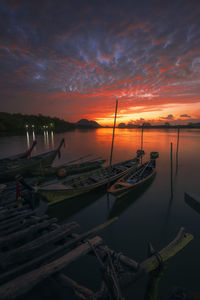 Boats in marina at sunset