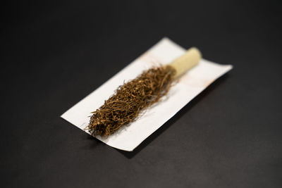 Close-up of bread on table against black background
