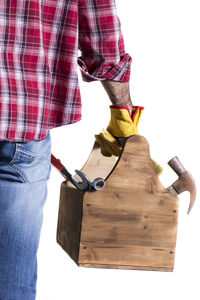 Low section of man standing against white background