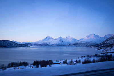 Winter panorama of mountains and frozen bay water in norway.