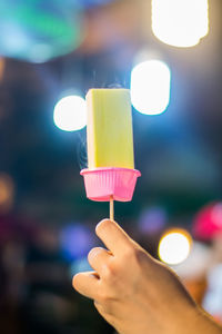 Close-up of hand holding ice cream