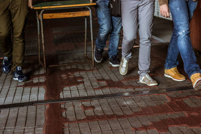 Low section of people standing on road