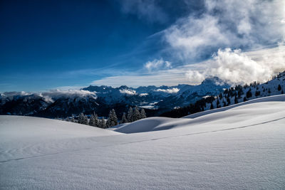 Scenic view of snow covered mountains against sky