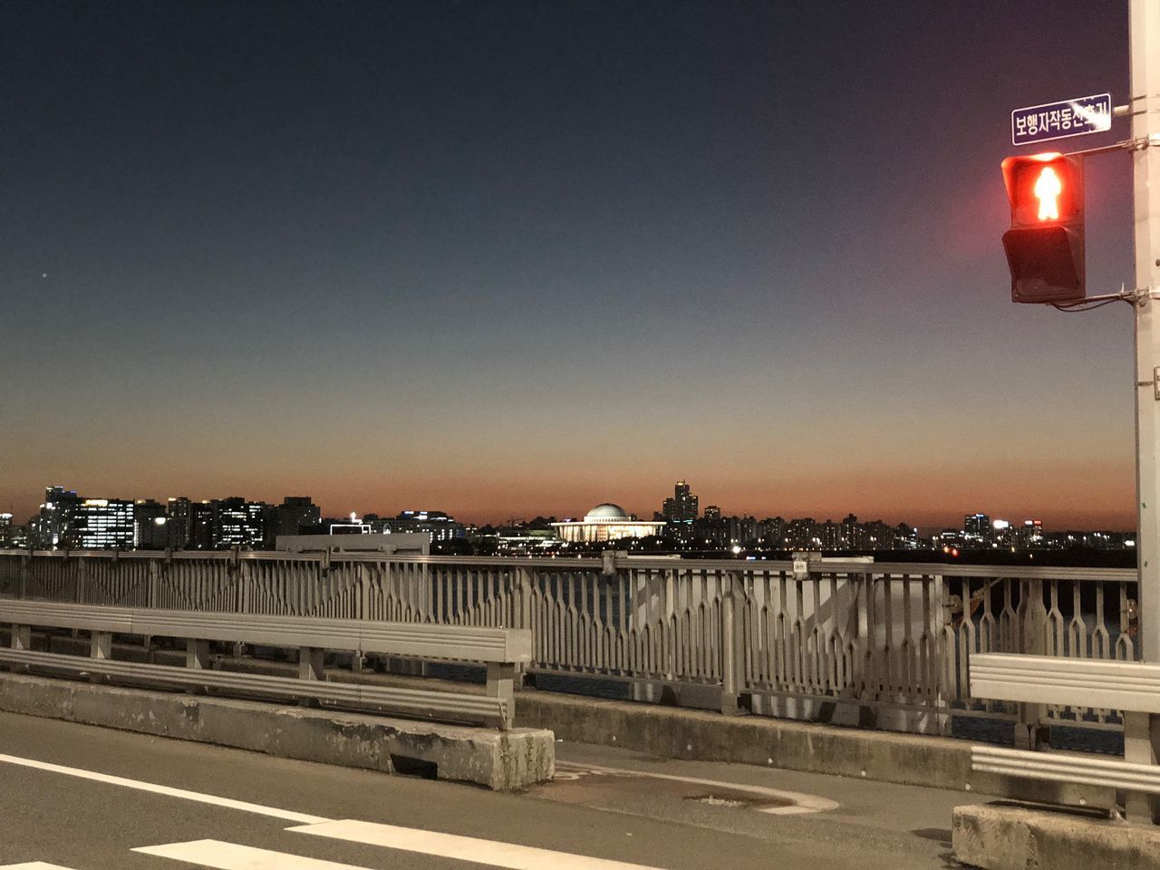 ILLUMINATED BRIDGE AGAINST SKY IN CITY