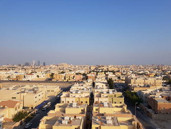 High angle view of townscape against clear blue sky