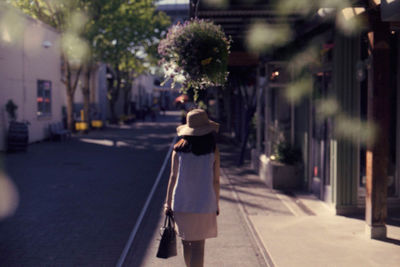 Rear view of woman walking in city