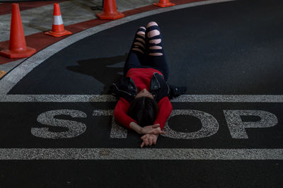 High angle view of man sitting on road