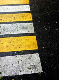 High angle view of yellow arrow symbol on road