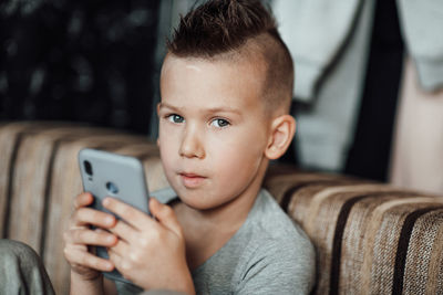 Portrait of baby boy using mobile phone