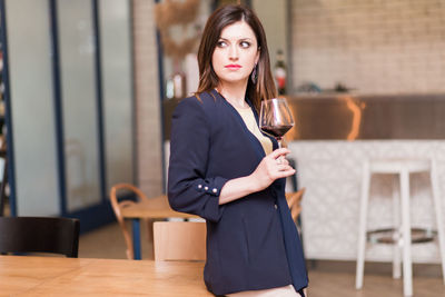 Beautiful young woman holding wineglass