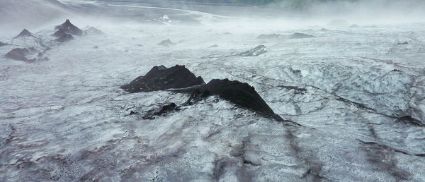 Scenic view of snow covered rock