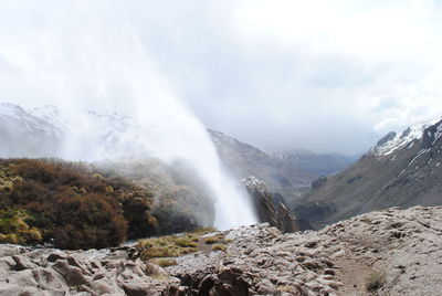 Scenic view of waterfall against sky