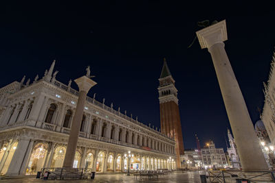 Low angle view of illuminated building against sky at night