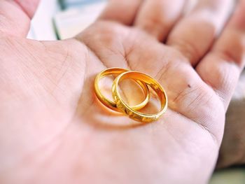 Midsection of person holding wedding rings