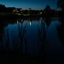 Scenic view of lake against sky at night