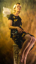 Portrait of young woman sitting on stage