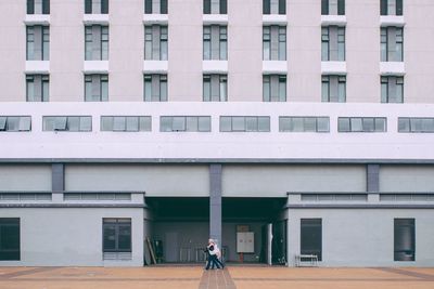Man in front of building