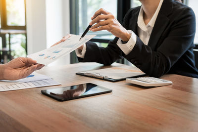 Close-up of woman working on table