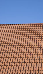 Low angle view of modern building against clear blue sky