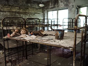 Boy sleeping on table in abandoned room