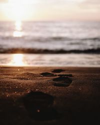 Close-up of sand at beach against sky