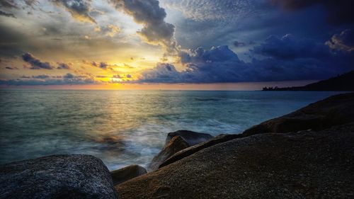 Scenic view of sea against sky at sunset