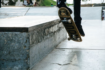 Low section of person skateboarding on footpath