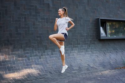 Full length of woman on wall