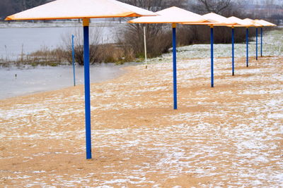 Wooden posts on snow covered land