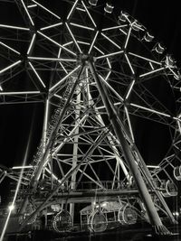 Low angle view of illuminated ferris wheel at night