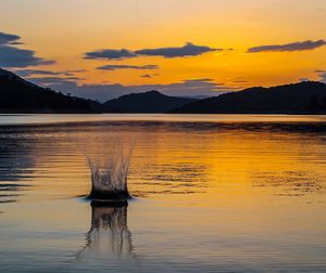 Scenic view of lake against sky during sunset