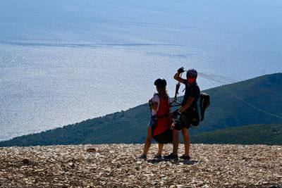 Rear view of men standing on mountain