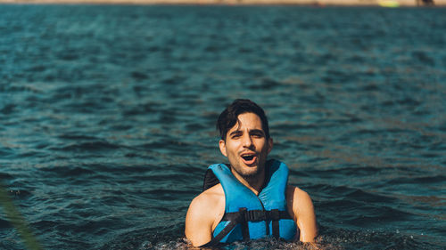 Portrait of young man in sea