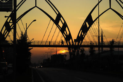 Silhouette bridge against sky at sunset