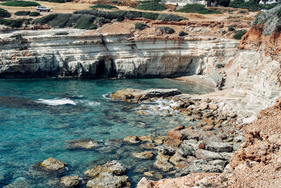 High angle view of rock formations at seaside