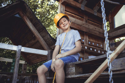 Portrait of smiling girl sitting on wood