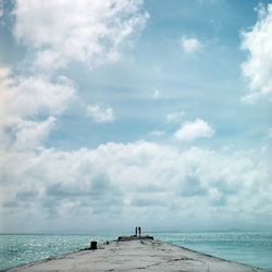 Scenic view of sea against cloudy sky