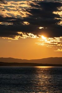 Scenic view of sea against romantic sky at sunset