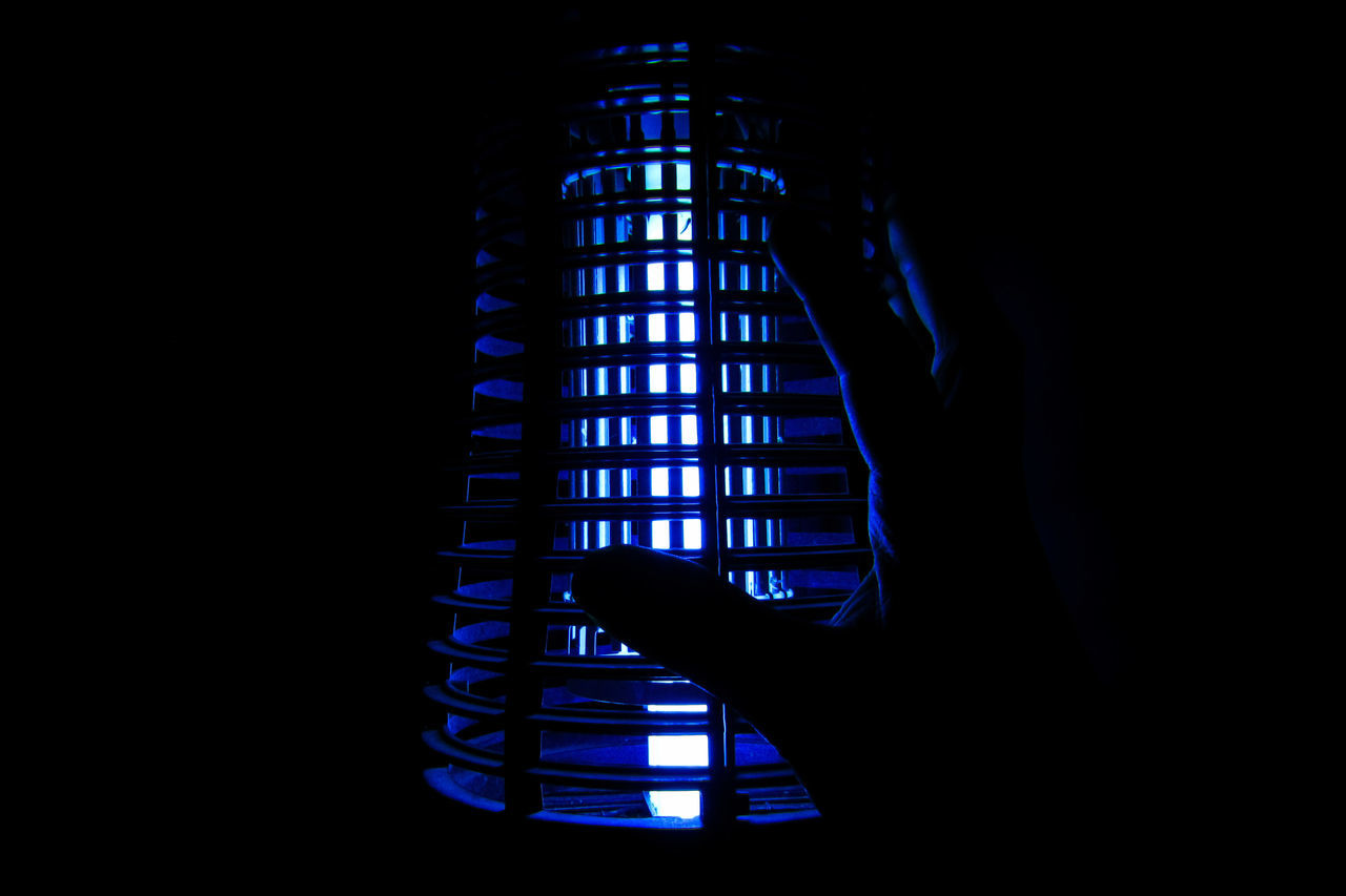 LOW ANGLE VIEW OF SILHOUETTE PERSON HOLDING ILLUMINATED LIGHT