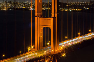 Illuminated suspension bridge at night